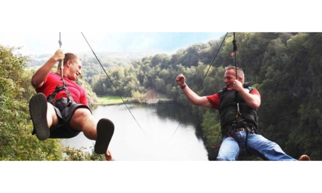 Friends go down the zip wire at Adrenalin Quarry